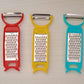 Set of kitchen tools including peeler, grater, and cutter for vegetables